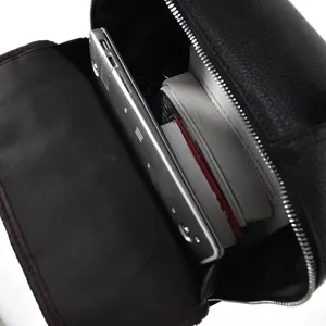Interior detail shot of black leather business backpack showing large capacity for your laptop.