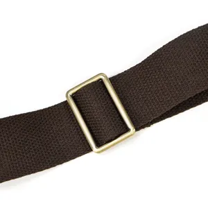 Close-up detail of the durable brown fabric shoulder bag strap with adjustable metal buckle.