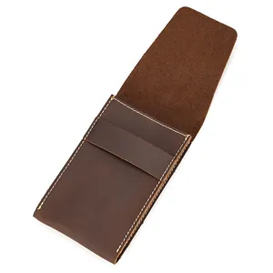 Detail shot of vintage brown crazy horse leather watch pouch with white stitching close up.