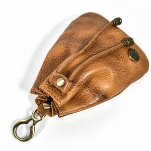 Close-up detail of vintage handmade vegetable-tanned leather coin purse with metal clasp.