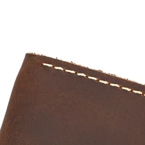 Close-up detail of genuine crazy horse leather watch pouch edge stitching and texture.