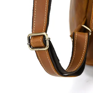 Close-up detail of genuine crazy horse leather backpack strap and metal buckle, durable.