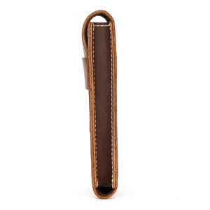 Close-up view of genuine leather watch pouch side detail, vintage brown cowhide texture.