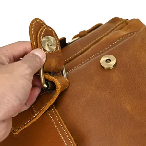 Close-up detail of vintage crazy horse leather backpack metal hardware buckle and stitching.