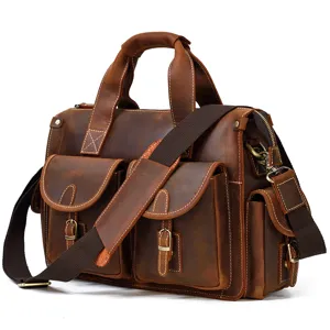 Close-up detail of the vintage leather briefcase showcasing multiple pockets and metal hardware.