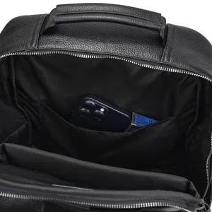 Detailed view of black leather business laptop backpack interior storage space and laptop compartment.