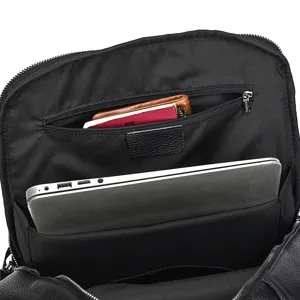 Detailed view of the black leather backpack interior featuring a laptop compartment and zipper pocket.