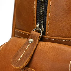 Close-up detail of vintage crazy horse leather men backpack zipper and stitching craftsmanship.