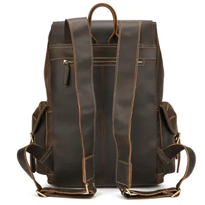 Detail view of vintage genuine leather backpack back straps, metal zippers and side pockets.