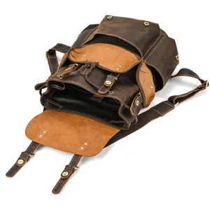 Vintage crazy horse leather backpack detail showing multiple pockets and bronze hardware.