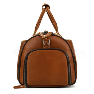 Brown leather travel duffel bag detail, vintage zipper pocket, sturdy handles and metal rings.