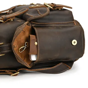 Close-up detail of vintage crazy horse leather backpack, showcasing front pocket and hardware.