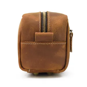 Genuine leather toiletry bag side detail, showcasing vintage texture and heavy zipper.