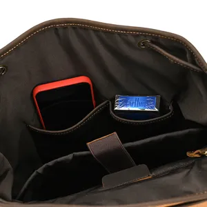 Detailed view of genuine leather backpack interior with multiple storage pockets.