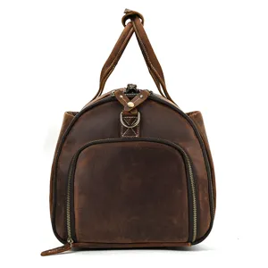 Vintage brown leather travel duffel bag detail showing durable brass zippers and handles.