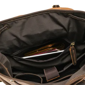 Leather backpack interior detail, dark brown retro design with multiple pockets and zipper compartment.