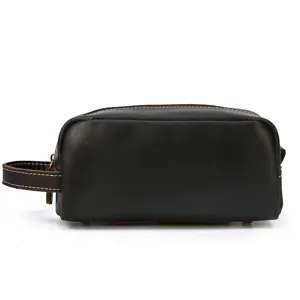 Detailed view of the premium leather brown dopp kit with contrast stitching and side handle.