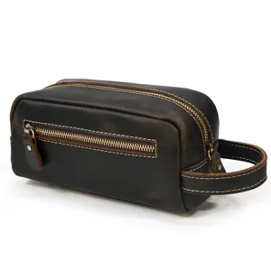 Close-up detail view showing the durable metal zipper and side handle of the leather bag.