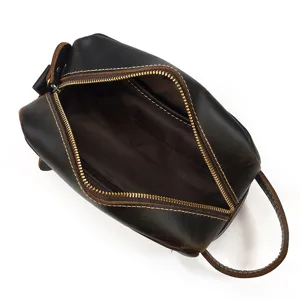 Detailed view of genuine leather toiletry bag, interior lining and sturdy metal zipper.