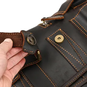 Close-up view of the vintage crazy horse leather backpack showcasing fine stitching and brass snaps.