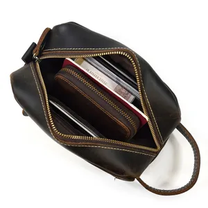 Genuine leather toiletry bag detail showing large capacity interior space for travel essentials.