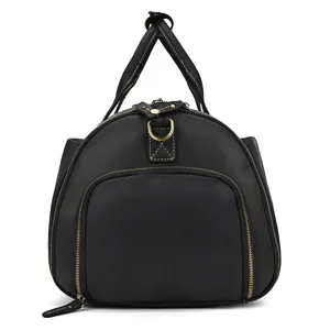 Detail view of black leather travel duffel bag, classic design with sturdy handles and zippers.