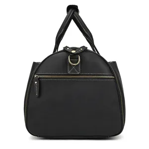 Black leather travel duffel bag detail close-up showing premium stitching and hardware zippers.