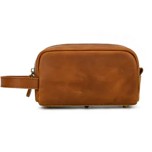 Detail view of the retro genuine leather toiletry bag showing fine texture and handle.