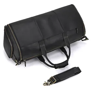 Black genuine leather vintage travel duffel bag, detail view showing texture and hardware.