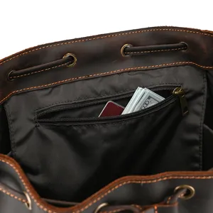 Detail shot showing the spacious interior and zippered pocket of the retro leather backpack.