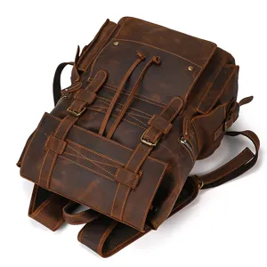 Detail view of vintage crazy horse leather backpack, showcasing multi-pocket and metal buckles.