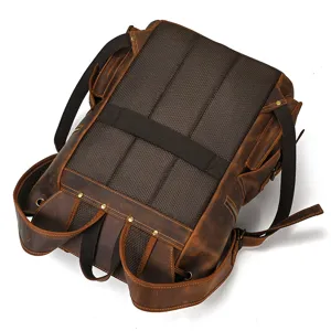 Detailed view of brown crazy horse leather backpack showing back mesh panel and adjustable straps.