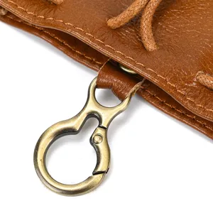 Close-up detail of retro crazy horse leather coin pouch with bronze clasp and strap.