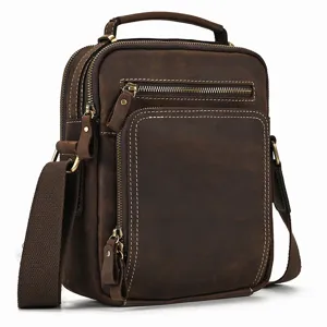 Detailed view of vintage brown leather men shoulder bag, multi-pocket crossbody design.