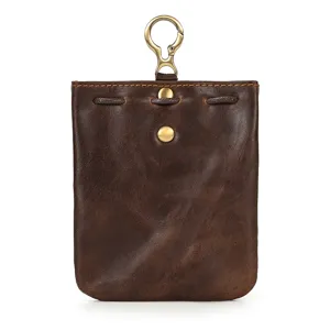 Detail view of vintage genuine leather coin pouch with metal hook and snap closure texture.