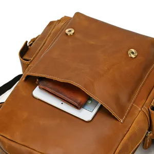 Detail shot of brown crazy horse leather backpack showcasing front pocket and premium material.