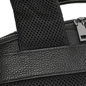 Men genuine leather backpack detail close up showing fine texture, mesh fabric and metal zippers.