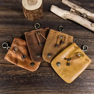 Close-up view of retro handmade vegetable-tanned leather coin purses in various brown shades.