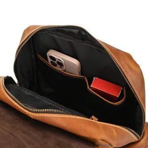 Detail view of the leather backpack interior, featuring multi pockets and organized storage.