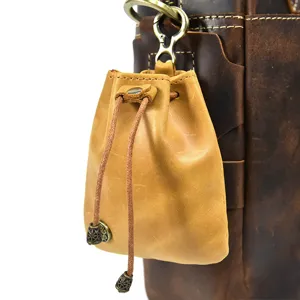 Handcrafted vintage mini leather coin purse, small drawstring pouch for women, retro style.