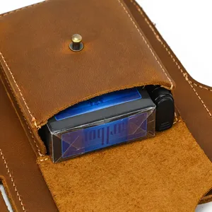 Close-up detail of vintage genuine crazy horse leather belt pouch, showing fine stitching.