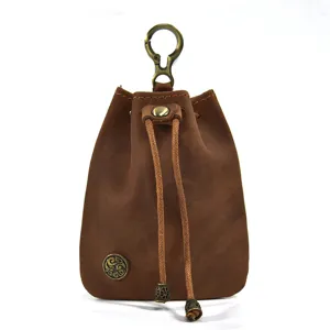 Vintage handmade vegetable-tanned leather coin pouch mini drawstring bag with metal clasp.