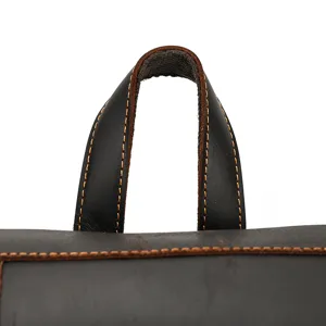 Close-up detail of genuine crazy horse leather backpack top handle with strong reinforced stitching.
