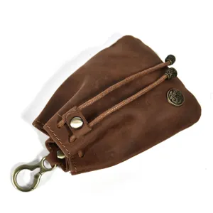 Close-up detail of retro handmade vegetable-tanned leather coin purse with metal hardware.