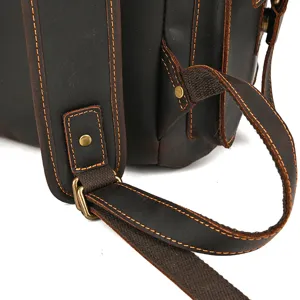 Detailed view of vintage crazy horse leather backpack strap and metal hardware craftsmanship.