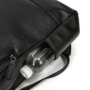 Detail view of black men's business leather backpack side pocket holding water bottle clearly.