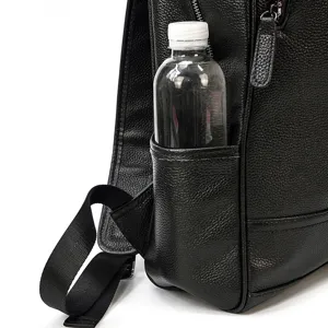 Close-up detail of black genuine leather business backpack side pocket and strap.
