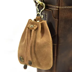 Mini vintage leather drawstring coin purse detail, handmade retro change bag hanging hook.
