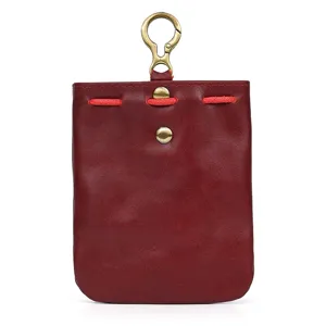 Close-up detail of vintage vegetable-tanned leather coin pouch with clasp and snap button.