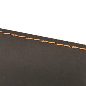 Close-up detail of genuine crazy horse leather texture with neat contrast stitching brown.